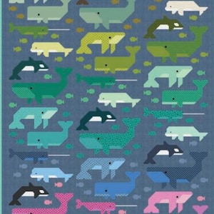 May include: A quilt featuring a repeating pattern of whales, narwhals, and orcas in various shades of green, blue, and pink against a dark blue background. The marine animals are depicted in a geometric style, interspersed with small fish icons.