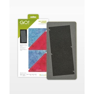 May include: A die-cutting tool for fabric, labeled "GO!" and "HALF SQUARE TRIANGLE." The packaging shows examples of fabric cut into triangles in red and blue. The die itself is gray and rectangular with triangle cutouts.