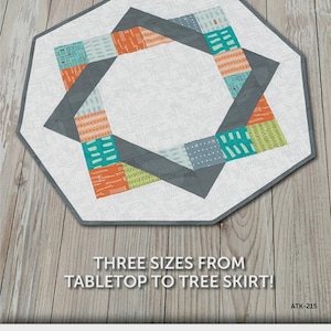 May include: An octagonal quilt pattern with the text "GATHER ROUND". The quilt features a central ring design with colorful patchwork in shades of orange, teal, and gray. The text "THREE SIZES FROM TABLETOP TO TREE SKIRT!" is also visible.