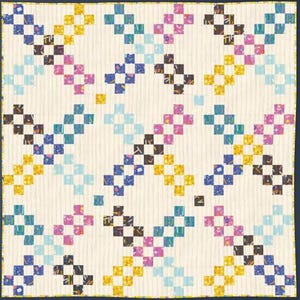 May include: A handmade quilt with a repeating pattern of colorful squares. The squares are arranged in diagonal rows, with colors including blue, yellow, pink, and black. The quilt has a cream-colored background and a dark blue border.