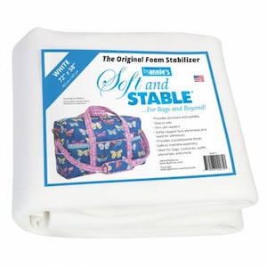 May include: White foam stabilizer sheet, 72 inches by 58 inches, for bags and beyond. The sheet is shown folded in half. The product label features the text "The Original Foam Stabilizer by Annie's Soft and STABLE" and a small American flag.