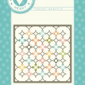 May include: A quilt pattern called "Ebb and Flow" from "Pieces From My Heart" by Sandy Servias. The pattern features a white background with a grid of colourful squares.