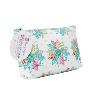 May include: A white vinyl zipper pouch with a colorful patchwork floral pattern. The pouch has a mint green zipper and a tag that reads "Bee Vintage VINYL ZIPPER POUCH". The floral design includes shades of blue, green, pink, and purple.