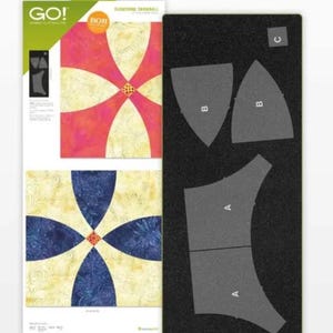 May include: A quilting die set with a black cutting mat and two fabric samples. The fabric samples feature a floral design in pink, yellow, and blue. The die set includes the text "GO!" and "Flowering Snowball".