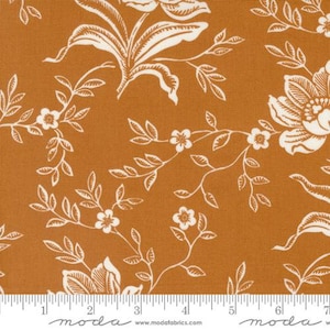 May include: A fabric with a repeating floral pattern. The background is a warm, earthy orange, and the design features white flowers, leaves, and vines. The fabric is suitable for quilting, sewing, and other craft projects.