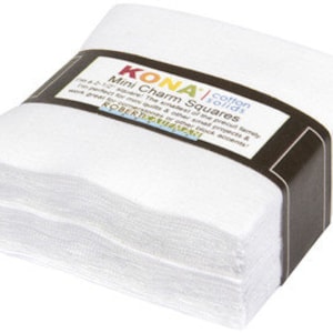 May include: A stack of white Kona Cotton Solids Mini Charm Squares, each measuring 2.5 inches. The squares are packaged in a clear plastic bag with a brown label that reads "Kona Cotton Solids Mini Charm Squares".