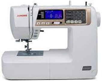 May include: White sewing machine with a gold trim and a digital display. The machine has a large foot pedal and a needle threader.