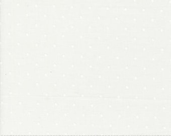 May include: Off-white fabric with a subtle dotted pattern. The dots are small and evenly spaced across the surface. A ruler is visible along the bottom edge, with the Moda logo and website address.
