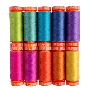 May include: Ten spools of Aurifil thread in a variety of colours, including green, teal, blue, purple, pink, orange, and yellow. The spools are labelled "100% Cotton - Ne 50" and "Aurifil Made in Italy".