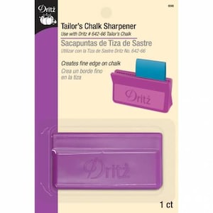 May include: Purple plastic tailor's chalk sharpener with a Dritz logo. The sharpener is designed to create a fine edge on chalk. The text on the packaging reads "Tailor's Chalk Sharpener", "Use with Dritz # 642-66 Tailor's Chalk", "Sacapuntas de Tiza de Sastre", "Utilizar con la Tiza de Sastre Dritz No. 642-66", "Creates fine edge on chalk", "Crea un borde fino en la tiza", and "1 ct".