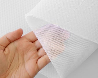 May include: White mesh fabric with a fine, even weave. The fabric is soft and flexible, and it has a slightly textured surface.