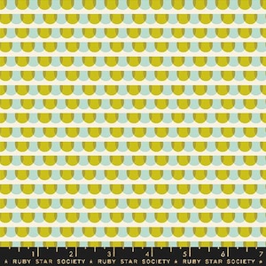 May include: A white fabric with a repeating pattern of overlapping yellow and blue half-circles. The fabric is marked with a ruler in inches and the text "RUBY STAR SOCIETY".