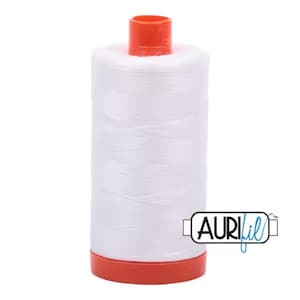 May include: A spool of white thread with a red top and bottom. The spool is labeled "Aurifil" in blue lettering.