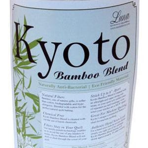 May include: A rolled white fabric with a label reading "Kyoto Bamboo Blend." The label has green bamboo leaf designs and text: "Naturally Anti-Bacterial | Eco Friendly Material." The product is a "Full" size, measuring 206cm x 244cm.
