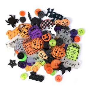 May include: A selection of Halloween-themed embellishments, featuring orange pumpkin and ghost-shaped buttons, black spiders, and the words "Happy", "Trick or Treat", and "Scary". A variety of colours and shapes are visible.