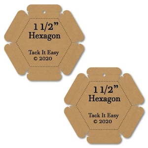 May include: Two brown cardboard hexagon shapes with the text "1 1/2" Hexagon" and "Tack It Easy © 2020" printed in black. Each shape has a small hole at the top for hanging.