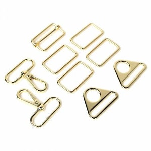 May include: A set of gold-toned metal hardware for bags and other crafts. The set includes rectangular and triangular rings, as well as a swivel hook.