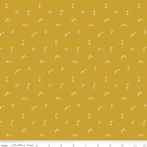 May include: A mustard yellow fabric with a repeating pattern of white crescent moons and stars.