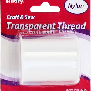 May include: A white spool of clear nylon thread for craft and sewing projects. The packaging is red and white with the words "Allary Craft & Sew Transparent Thread Nylon" and "Item No. 406".