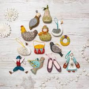 May include: A collection of 15 handmade felt Christmas decorations featuring various animals, birds, and people. The decorations are decorated with colourful patterns and designs, including a swan, a drum, a pear, a bird, and a woman in a blue dress.