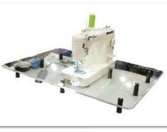 May include: A white sewing machine with a clear plastic extension table. The table has black legs and is sitting on a white surface.