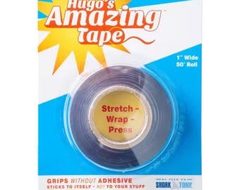 May include: A roll of Hugo's Amazing Tape, 1 inch wide and 50 feet long, packaged on a blue and white card. The tape is black and has the words "Stretch - Wrap - Press" on the center. The packaging also states "Grips Without Adhesive".
