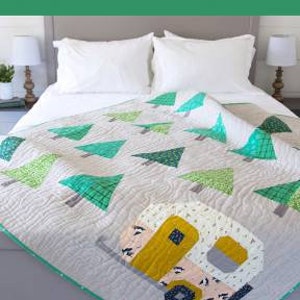 May include: A quilt pattern featuring a camper and trees, with the text "Up North Quilt" and "Standard piecing quilt pattern for beginner level sewers and up".