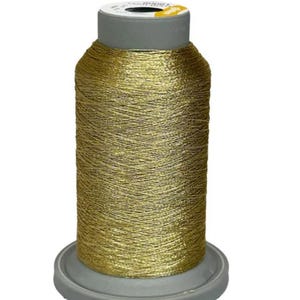 May include: A spool of gold metallic thread for sewing or embroidery.