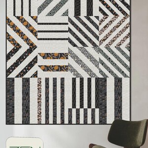 May include: A large quilt with a geometric design featuring bold black and white stripes, along with sections of patterned fabric in black, gray, and orange. The quilt is labeled "BOLD STRIPES" and "ZEN CHIC BRIGITTE HEITLAND".