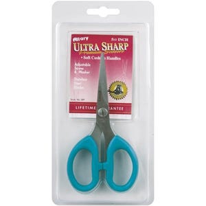 May include: A pair of Ultra Sharp scissors in a clear plastic package. The scissors have teal handles and stainless steel blades. The packaging includes the text "Ultra Sharp Premium Scissors" and "5 1/2 inch".