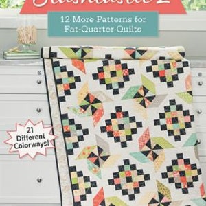 May include: A book titled "Stashtastic 2" with a quilt on the cover. The book features 12 patterns for fat-quarter quilts and 21 different colorways. The author is Doug Leko.