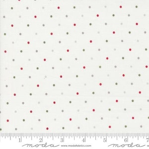 May include: White fabric with a repeating pattern of red, green, and gray polka dots. The dots are evenly spaced across the surface. A ruler is visible along the bottom edge.