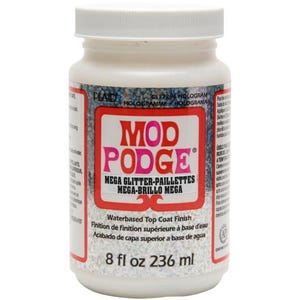 May include: A white plastic bottle of Mod Podge Mega Glitter, a water-based top coat finish. The label features the brand name in red and the product description in English, French, and Spanish. The bottle contains 8 fl oz (236 ml).