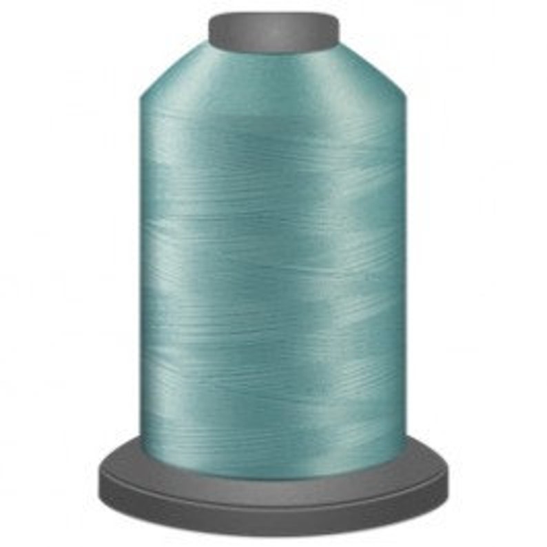 May include: A spool of light blue sewing thread.