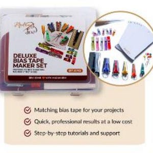 May include: A Deluxe Bias Tape Maker Set in a clear plastic case. The set includes various colored bias tape makers, clips, and a set of instructions. The text on the package reads "DELUXE BIAS TAPE MAKER SET".