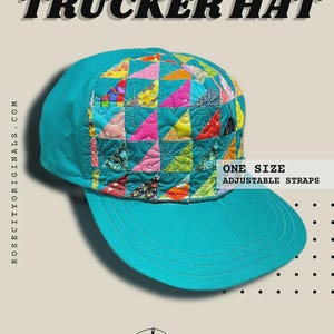 May include: Teal quilted trucker hat with a colorful patchwork design on the crown. The hat features the text "QUILTED TRUCKER HAT" and "ONE SIZE ADJUSTABLE STRAPS". The brand logo is visible. Skill level: Intermediate.