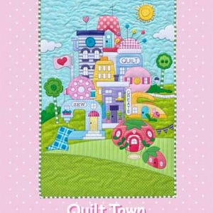 May include: A colourful quilt pattern featuring a whimsical town with buildings shaped like sewing machines, a quilt, and a strawberry. The quilt pattern is titled "Quilt Town" and includes full-size patterns, a placement sheet, and instructions for a 20" x 20" wall hanging.