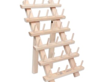 May include: A wooden thread spool holder with multiple rows of pegs. The natural wood-toned rack is angled, with a sturdy base and multiple levels for organizing spools. The pegs are evenly spaced, designed to hold thread spools.