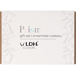 May include: A white gift set box with the word "Prism" in silver and blue lettering, and the text "gift set | ensemble cadeau". The box is decorated with a pattern of scissors and the brand "VLDH SCISSORS". The box is wrapped in a brown cardboard sleeve.