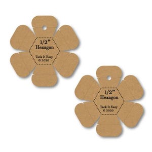 May include: Two brown paper hexagon templates, each with a 1/2-inch hexagon design and the text "1/2" Hexagon" and "Tack It Easy © 2020". The templates are shaped like flowers with six petals and a hole at the top.
