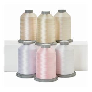May include: Six spools of thread in various shades of white, cream, and pink. The spools are arranged in two rows of three, with the top row featuring cream shades and the bottom row featuring lighter shades of pink and white.
