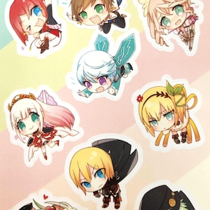 May include: A sheet of colorful stickers featuring chibi-style anime characters with large eyes and various outfits. The stickers include characters with red, brown, blonde, and white hair, with wings and other accessories. Text at the bottom reads "Tales!" and an email address.