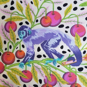 May include: A purple monkey sits on a branch with green leaves and pink, red, and orange cherries. The background is white with black polka dots.