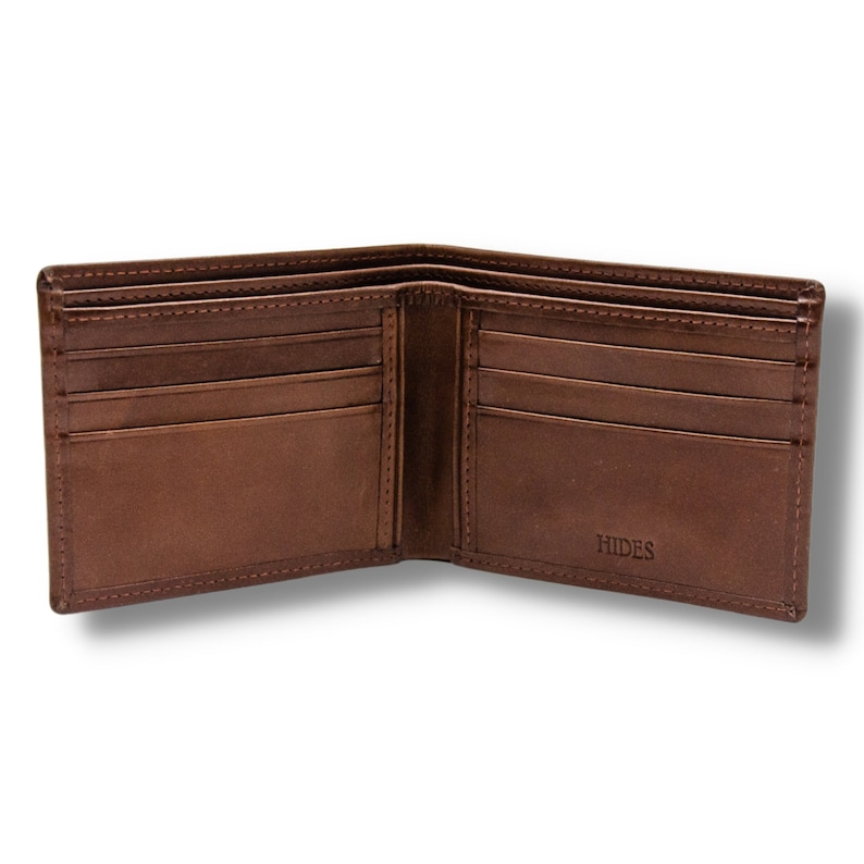 May include: A brown leather wallet with multiple card slots and a billfold. The wallet is open and the inside is visible. The brand name "HIDES" is embossed on the inside of the wallet.