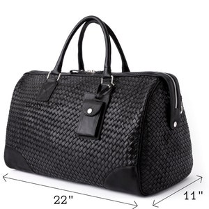 May include: Black leather woven duffel bag with a top handle and a zipper closure. The bag measures 22 inches wide, 13 inches tall, and 11 inches deep.