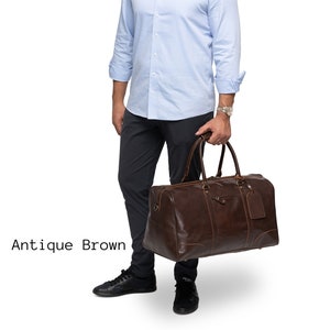 May include: Antique brown leather travel duffel bag with a zipper closure and a small leather tag.