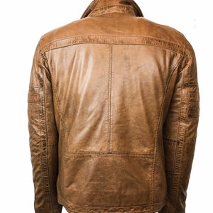 May include: A brown leather jacket with a zipper closure and a stand-up collar.