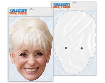 May include: A white cardboard package with a cutout of a person's face. The package has the text "Celebrity Face Mask" printed on it in blue and red letters.