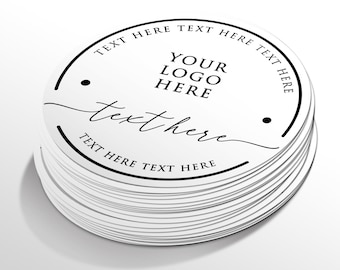 Könnte beinhalten: Ein Stapel weißer, runder Aufkleber mit schwarzem Text und Designelementen. Der Text enthält "TEXT HERE" oben und unten, "YOUR LOGO HERE" in der Mitte und "text here" in kursiver Schrift. Zwei schwarze Punkte und ein schwarzer Kreisrand sind ebenfalls vorhanden.