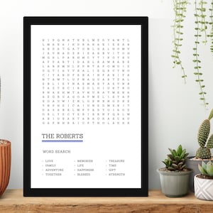 May include: A black framed word search puzzle with the title "The Roberts" and a list of words to find, including love, family, adventure, together, memories, life, happiness, blessed, treasure, time, gift, and strength.
